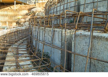 Adding Metal Reinforcement To Concrete Blocks During Construction. Concrete Blocks On The Constructi