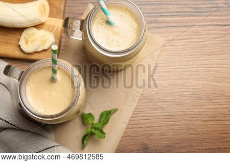 Tasty Banana Smoothie And Mint On Wooden Table, Flay Lay. Space For Text