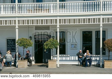 Martinborough New Zealand October 4 2010;  People Sitting Outside Enjoying Sun And Martinborough Hot