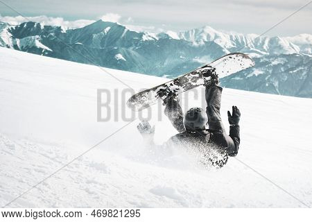 Snowboarder Fall Down On Back With Snow Splashes On Snowy Off-piste Ski Slope And Old Chair Lift At 