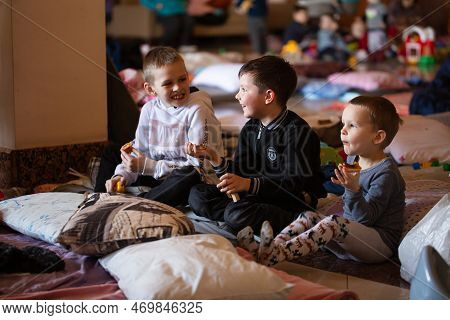 Ukrainian Refugees On Lviv Railway Station During Russian War. Refugee Kids In Waiting Hall