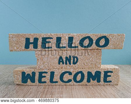 Hello And Welcome Symbol. Concept Words Hello And Welcome On Brick  Blocks. Beautiful Blue Backgroun
