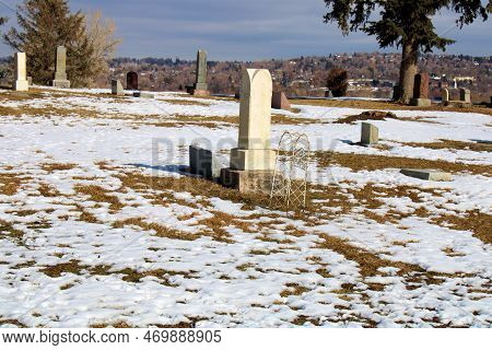 Vintage Headstones On Grave Sites At A Historical Cemetery Taken On A Hillside Overlooking The Commu