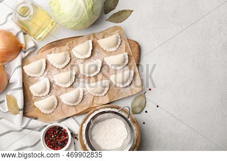 Raw Dumplings (varenyky) With Tasty Filling And Ingredients On Light Grey Table, Flat Lay. Space For