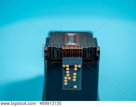 Cartridge With Paint For The Printer On A Blue Background. Close-up.