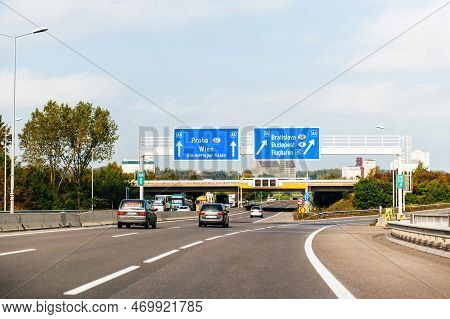 Austria - Sep 30, 2014: View From The Highway At The Blue Direction Signs Above With Praha, Wien, Si
