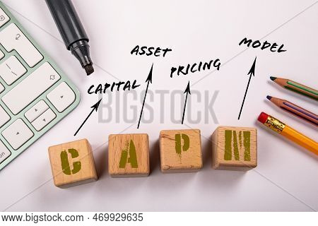 Capm - Capital Asset Pricing Model. Wooden Blocks On A White Office Table