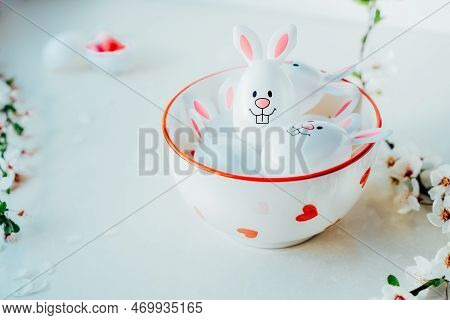 Close Up Funny Easter Eggs Containers With Bunny Ears Filled With Candy And Chocolate In A Bowl On T