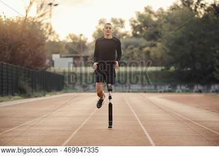 A Runner With Prosthetic Leg Running At The Stadium On Running Track.
