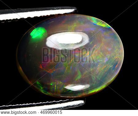 Natural Gemstone Rainbow Opal On Gray Background