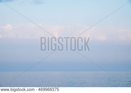 Background Of Sky And Sea, Sea Is Very Calm With Gentle Ripples, Sky Perfectly Clear. Calm Sea And B