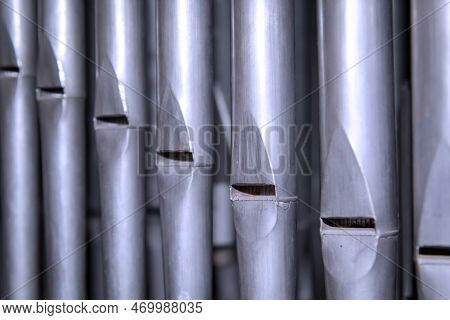 Metal Pipes Of A Church Organ, Close-up. Background. Many Organ Pipes Stand Side By Side In An Organ
