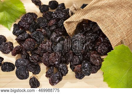 Healthy Food - Nuts Dehydrated Grapes; Photo On Wooden Background