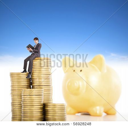 Smiling Young Man Counting Coin In Poggy Bank