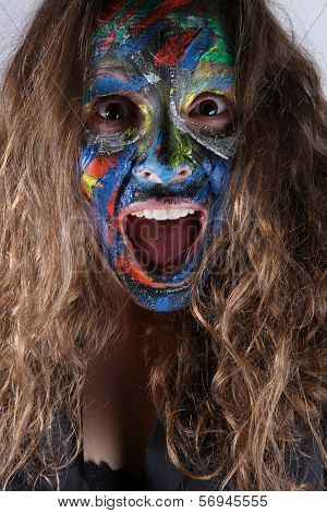young woman with face-art and scary expression