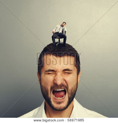 emotional man with small bored man on the head