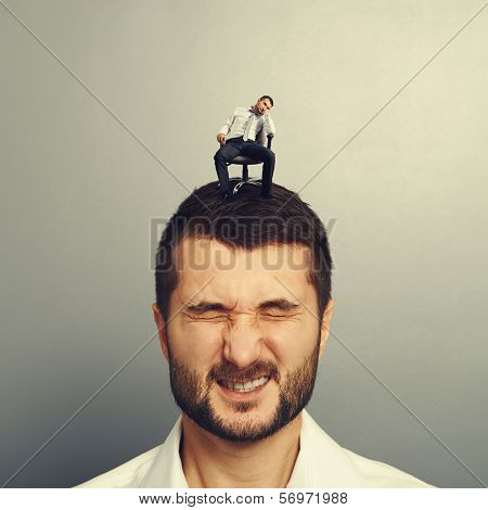 bored small man sitting on the head of another man