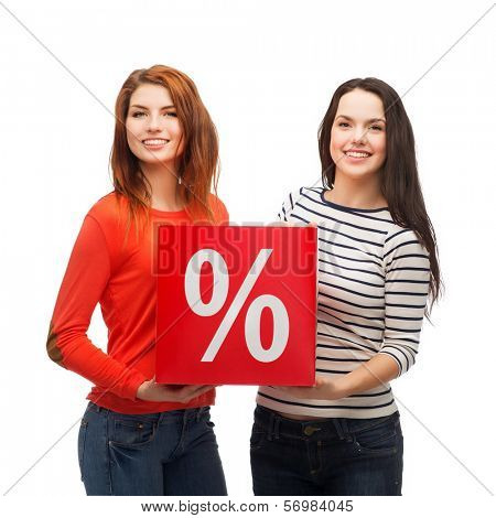 shopping, sale, and gift sconcept - two smiling teenage girls with percent sign on red box