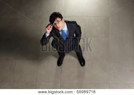 Image of young businessman in glasses. Top view