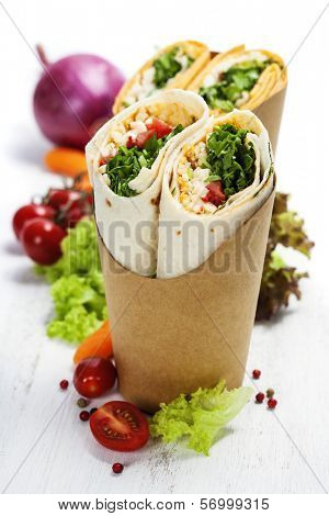 tortilla wraps with chicken and fresh vegetables isolated on white