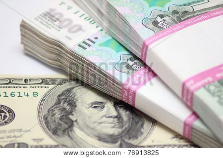 Hundred dollars and two packs to one thousand rouble banknotes