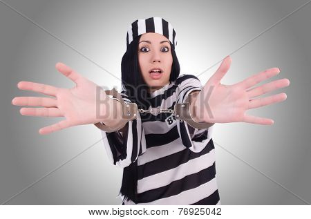 Prisoner in striped uniform on white