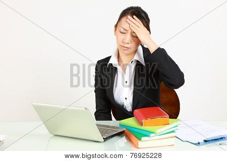 businesswoman suffers from headache