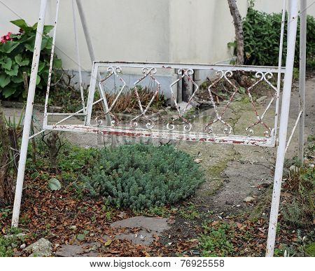 Abandoned Garden In Winter With Rocking Chair