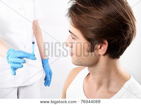 The vaccine, a man in his office nurse