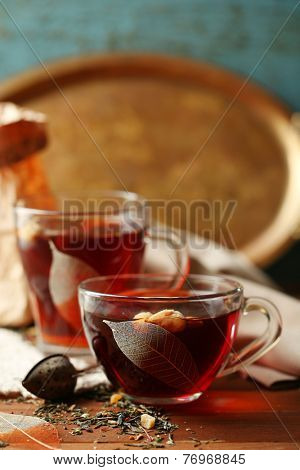 Beautiful vintage composition with herbal tea, on wooden table