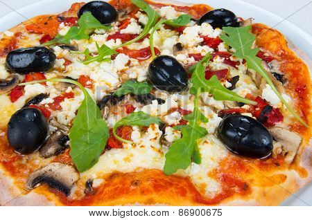 Pizza with cheese, mushrooms and olives.