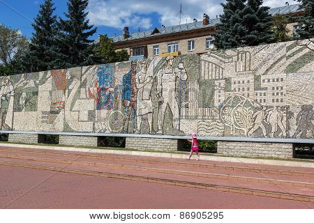 KOROLEV, RUSSIA - JULY 20, 2014: Child Walks Near Mosaic On The Central Square