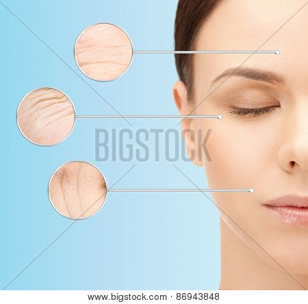 beauty, aging, people, skincare and health concept - beautiful young woman face with wrinkles over blue background