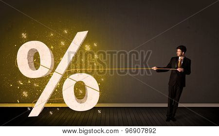 Business man pulling rope with big procent symbol sign concept on background