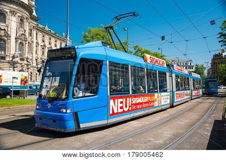 MUNICH GERMANY - JUNE 7 2016: Blue tram 28 on the Karlsplatz Stachus in Munich Bavaria Germany