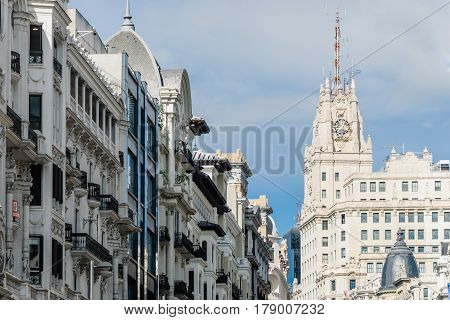 Madrid Spain - September 18 2016: Low angle view of buildings at Gran Via Street in Madrid. Telefonica Building on background. It is an important street in Central Madrid with shops and theaters.