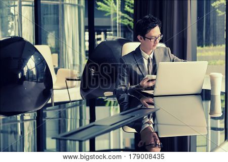 Smart Businessman Planning New Project On His Laptop And Hold Tablet In His Hand