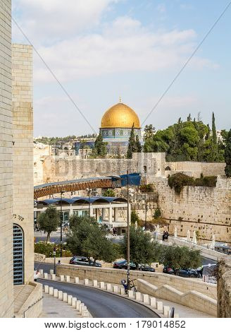 JERUSALEM ISRAEL - DECEMBER 8: The Western Wall the Dome of the Rock and the Mughrabi Gate on the Temple Mount view from the wall in the Old City of Jerusalem Israel on December 8 2016