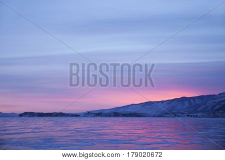 Lake Baikal winter. Cape Uyuga sunset landscape. Small sea