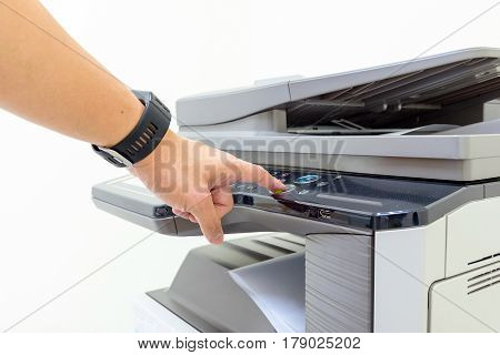 Copier Start - Finger pressing the start button on a multifunction printer or copier