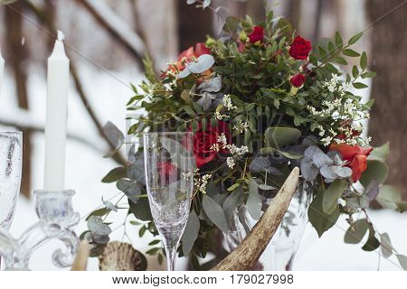 Wedding bouquet of yellow and white roses and blue fresia lying on wooden floor.