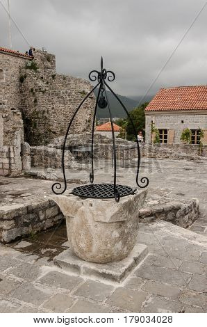 Old well in the square of the ancient city