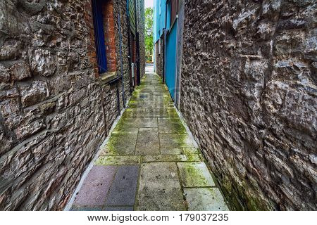 Narrow street. Ancient stone walls. Plymouth. Devon. England