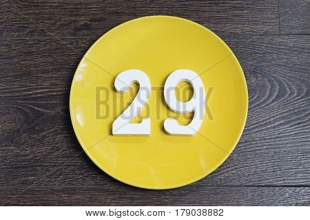 Figure twenty-nine on the yellow plate and brown background.
