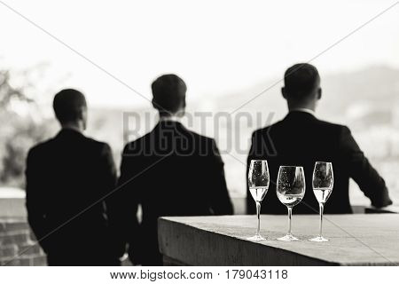 Glassware Stands On The Stone Porch In The Front Of Men Looking At The City
