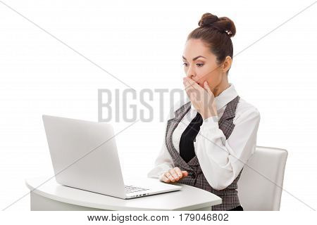 Image of young employer looking at laptop with surprise in office. Business and office concept surprised businesswoman using her laptop computer. Woman looking at pc screen against isolated white background