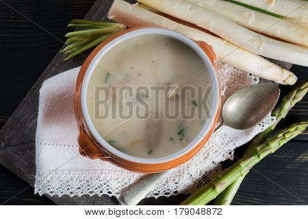 Spring season - white and green fresh asparagus cream- soup ready to eat with vegetables