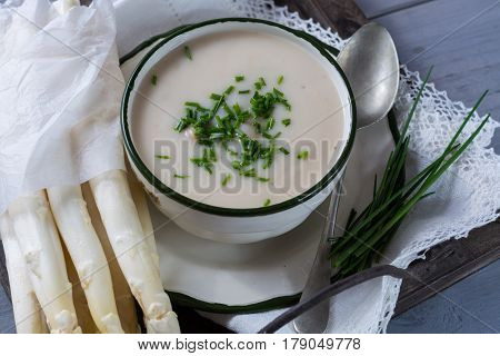 Spring season - white and green asparagus cream-soup ready to eat with chives