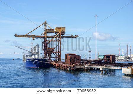 Labuan,Malaysia-Mac 25,2017:A large bulk carrier supplying iron ore in Antara Steel Mill Plant port at Labuan,Malaysia.The company produces billets and bars including angle bars and U-channels.