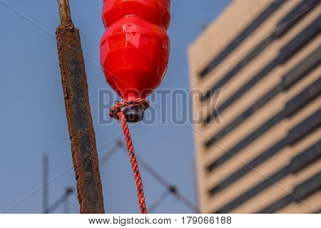 Seoul South Korea March 18 2017: Plastic bottle of red liquid hung from a rusted steel pole with rope extending from the cap to resemble a blood drip